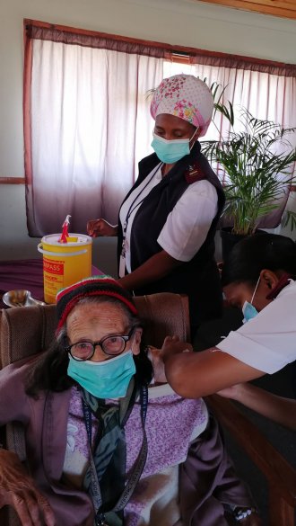 Ms Arna Theys aged 93 receiving her Pfizer booster vaccination.jpeg